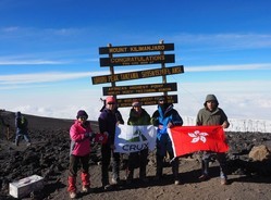 Reaching Uhuru Peak on Kilimanjaro with the Hong Kong flag
